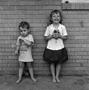 Primary view of [Two children standing in front of a brick wall #2]