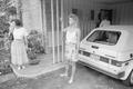 Photograph: [Two women standing near an automobile]