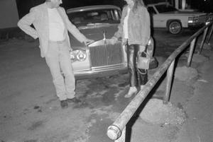 Primary view of object titled '[Byrd IV and Victoria Clary standing next to a car #1]'.
