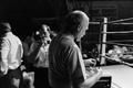 Photograph: [A man standing at the edge of a boxing ring #5]
