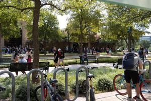 Primary view of object titled '[UNT students walking around the campuses' library mall]'.