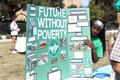 Photograph: [Student holding up a Future Without Poverty poster board]