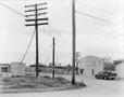 Photograph: [Railroad crossing and a pickup truck parked in the street]