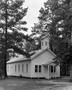 Photograph: [A small church building in a wooded area]