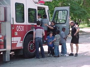 Primary view of object titled '[Children explore fire engine at ILD event]'.
