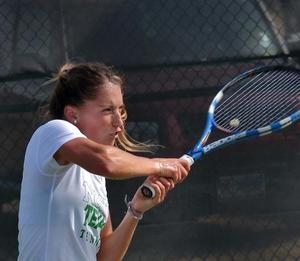 Primary view of object titled '[Augustina Valenzuela swings racket backhanded during Lamar match]'.