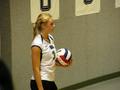 Photograph: [Ashley Bass holds volleyball on the court]