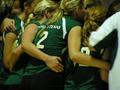 Photograph: [UNT volleyball team huddles during match, closeup]