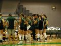 Photograph: [UNT volleyball team huddles on the sidelines]