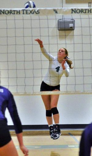 Primary view of object titled '[McKenna Thornlow serves volleyball]'.