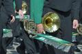Photograph: [Green Brigade trombone players walk 2011 Homecoming Parade, closeup]