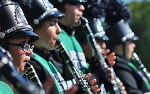 Primary view of object titled '[Green Brigade clarinet players perform at 2012 Homecoming Parade]'.