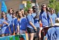 Photograph: [Fraternity and sorority members ride float at 2012 Homecoming Parade]