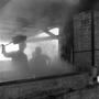 Primary view of [People standing near the sugar cane evaporator]