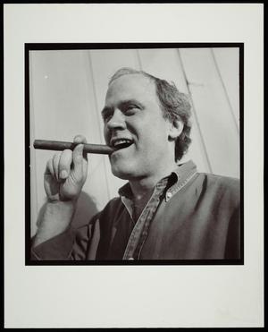 Primary view of object titled '[A man biting down on a cigar]'.