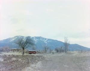 Primary view of object titled '[Abandoned farm and mountain with a dusting of snow]'.