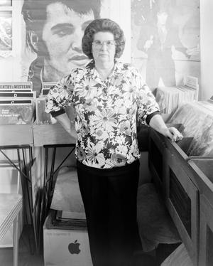 Primary view of object titled '[A woman standing inside a record store]'.