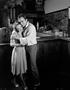 Photograph: [A Man and a Woman Hugging at a Bar]