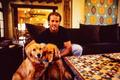 Photograph: [Mike Modano hugging his two golden retrievers for a picture]