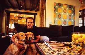 Primary view of object titled '[Mike Modano holding onto his two dogs, 2]'.