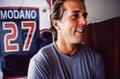 Photograph: [Mike Modano standing in front of his jersey]