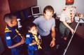 Photograph: [Mike Modano with three boy scouts in an office]