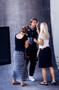 Photograph: [Two women adjusting Mike Modano for a photo shoot]