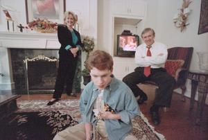 Primary view of object titled '[Michael Rowlett and parents in their living room, 2]'.