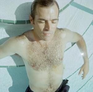 Primary view of object titled '[A man posing in a swimming pool by the steps, 2]'.