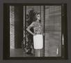 Thumbnail image of item number 1 in: '[Woman posing in a pleated skirt and abstract-print top, 1]'.