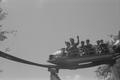 Photograph: [A man and five boys on an amusement ride at Six Flags Over Texas]
