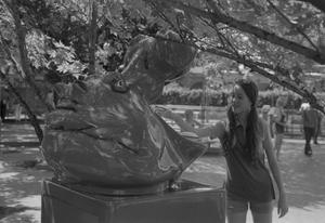 Primary view of object titled '[A girl viewing a hippo head statue at Six Flags Over Texas in Arlington, 2]'.