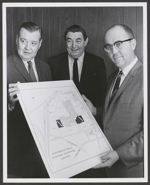 Primary view of object titled '[Photograph of W. K. Stripling Jr., Charles D. Tandy, and Paul Leonard holding a map]'.