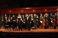 Primary view of [Haley Sicking and Kevin Park stand with Symphony Orchestra after "Nuit d'hyménée" performance]