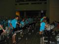 Photograph: [Rows of drummers in blue shirts performing for a crowd, 2]