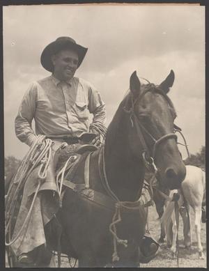 Primary view of object titled '[A man on horseback and smiling, at a livestock show]'.