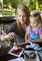 Photograph: [Sweet Moments Shared: Mother and Daughter Savor Desserts at the Wine…