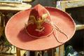 Photograph: [Regal Vintage Elegance: Antique Red Hat with Eagle Emblem Graces the…