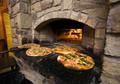 Primary view of [Savoring Tradition: Wood-Fired Pizza at Ancient Ovens, Saint Jo, Texas]