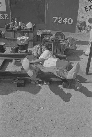 Primary view of object titled '[Two people hugging at the Terlingua Chili Cook-Off]'.