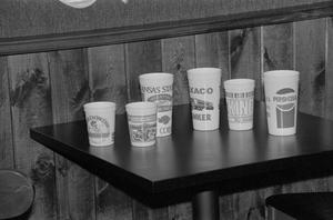 Primary view of object titled '[Cups on a table at the home of Willard Watson, "The Texas Kid", 1]'.