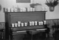 Thumbnail image of item number 1 in: '[Cups on a piano at the home of Willard Watson, "The Texas Kid", 4]'.