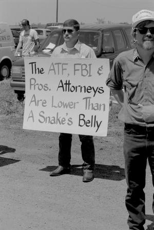 Primary view of object titled '[A man holding a sign at the Branch Davidian Annual Reunion]'.