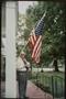 Photograph: [Man Behind American Flag]