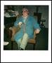 Photograph: [Elderly man in a blue robe sitting in an armchair]
