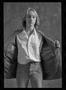 Photograph: [Woman holding her jacket open in a studio]