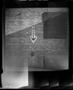 Photograph: [Arrow spray painted on the side of a brick building]