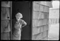 Photograph: [Elderly woman standing in a doorway]