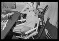 Photograph: [Woman holding a cigarette in a rocking chair]