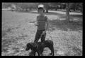 Photograph: [Young boy with a dog and a trophy]